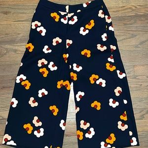 Far out cropped flower pant with pockets; white, pink and gold flowers on navy.